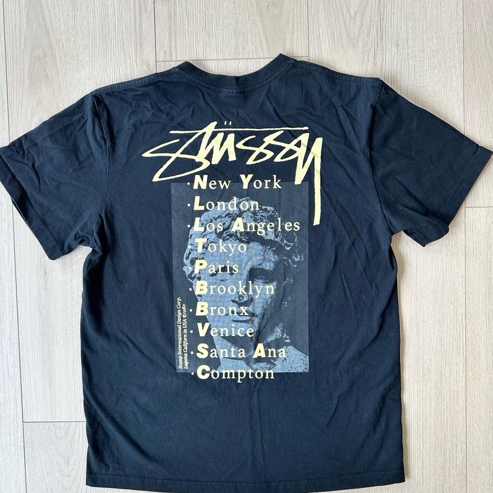 Stussy Black and Gold Graphic Tee